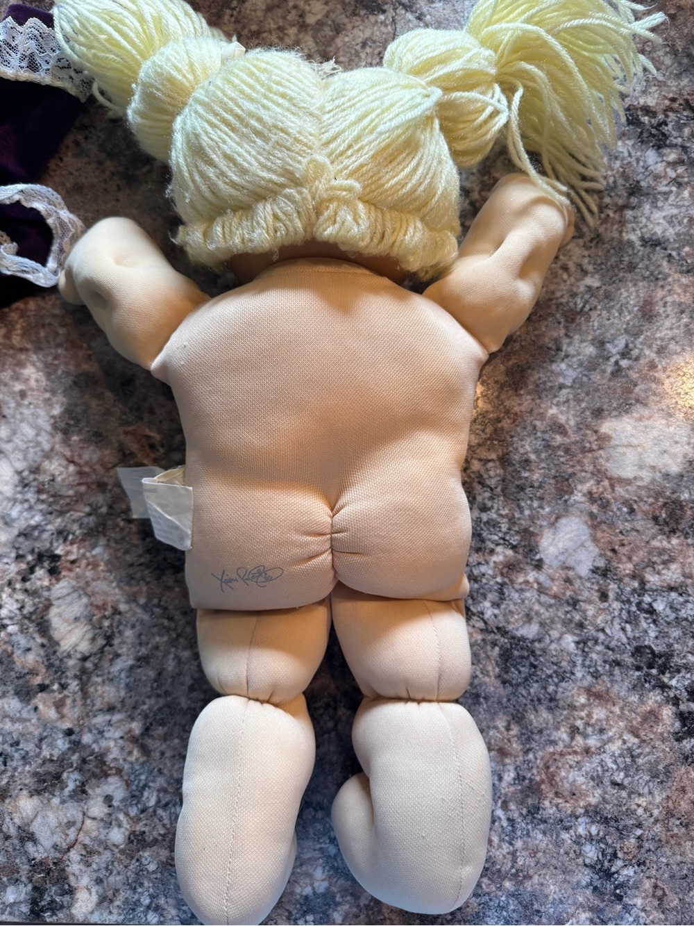 A Cabbage Patch Kid doll with blonde yarn hair and a purple dress - Picture 7 of 11